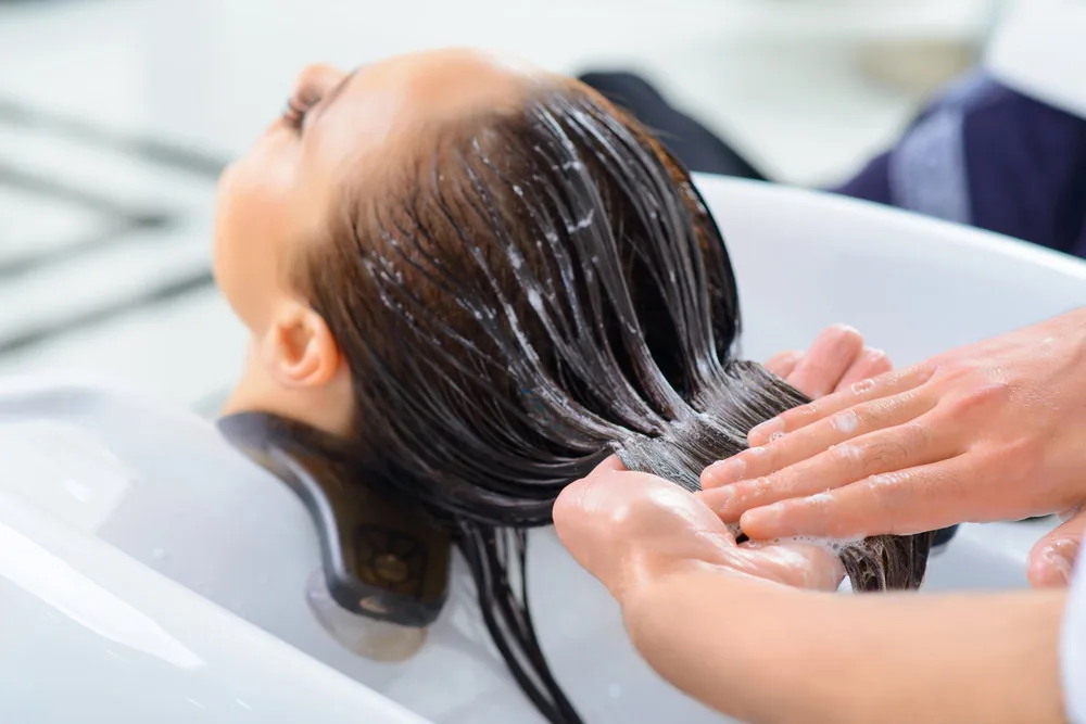 Conditioner being applied to the lengths of hair