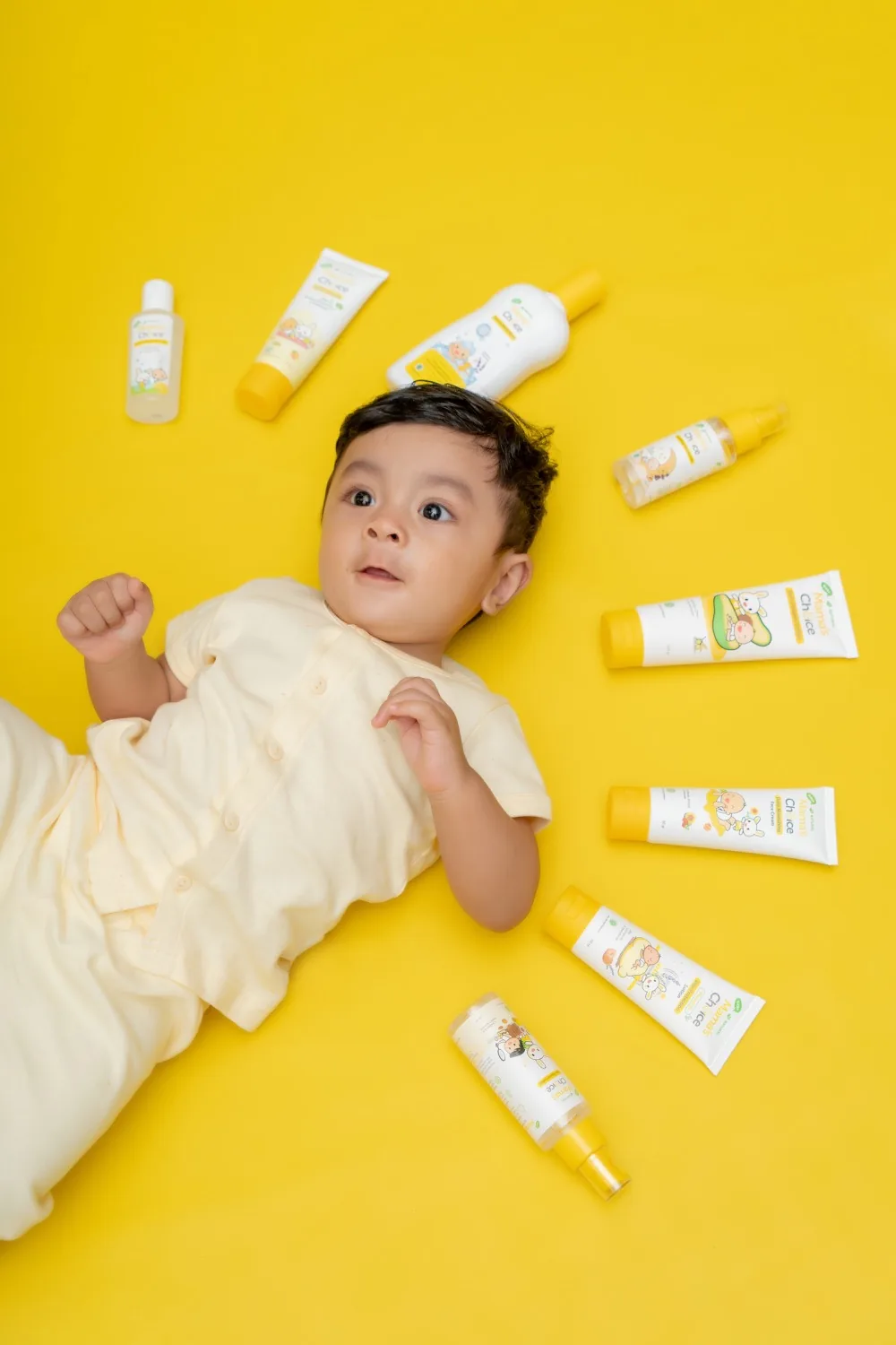 Baby care products arranged around a baby