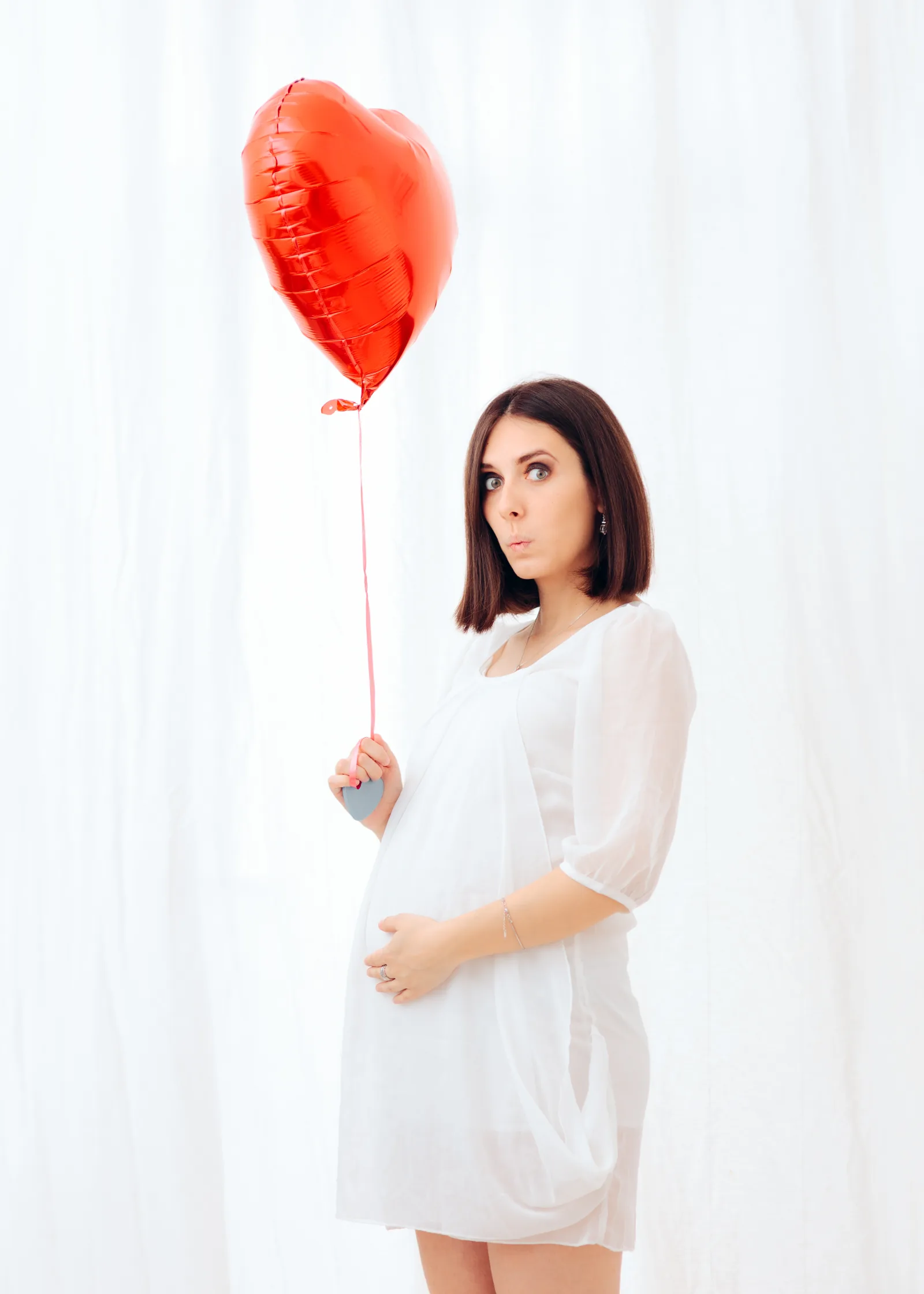 Pregnant woman in a white dress