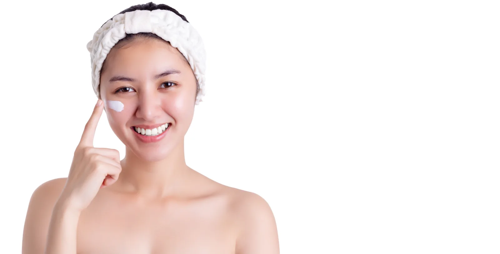 A woman applying face cream